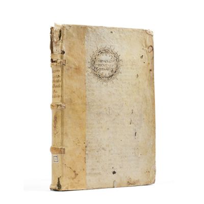 an old book sitting on top of a white table next to a white wall