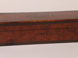 an old wooden box sitting on top of a white surface