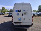 a white van with stickers on it parked in a parking lot