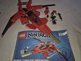a box of legos on a table next to a lego ninja jet