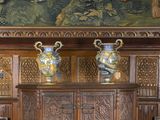 two vases sitting on top of a cabinet in a room