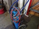 a blue cart with a hose on it in a garage