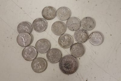 a pile of silver coins on a white surface