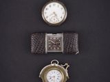 three different types of watches are displayed on a black surface