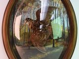 une photo d'un tableau représentant un faisan accroché au mur