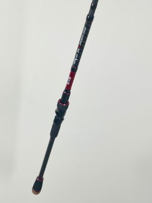 a close up of a person holding a fishing rod in their hand