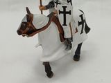 a figurine of a knight riding a horse in the snow