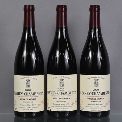 three bottles of wine are lined up on a table