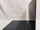an open laptop computer sitting on top of a white surface