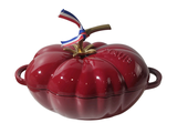 a red apple shaped dish with a blue ribbon on top