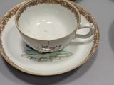 several cups and saucers are lined up on a table