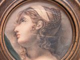 painting of a woman with a headband in a wooden frame
