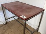 a wooden table with metal legs and a brown top