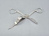 pair of scissors on a white surface with a gray background