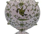 a vase with a bird on it on a white background