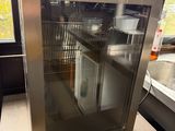 a small refrigerator that is sitting on a counter in a kitchen