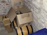 a wine barrel and a box in a room with a brick wall