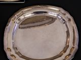 a silver tray and a silver plate on a table