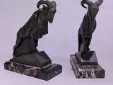 two statues of animals that are sitting on top of each other