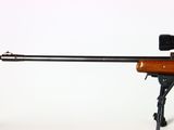 the rifle is sitting on a tripod with a scope on top of it