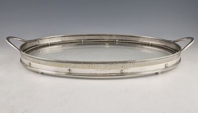 a silver tray with handles and handles on a white surface