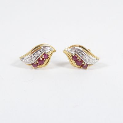 a pair of ruby and diamond earrings