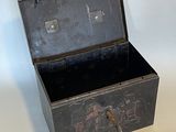 a small metal box with a handle on a table