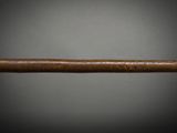 an old baseball bat with a wooden handle on a black background