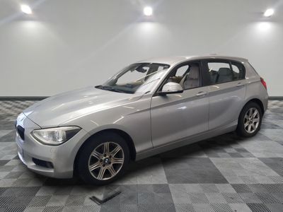an image of a silver bmw car in a showroom