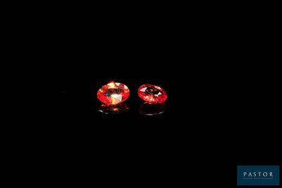 a pair of red sapphires on a black background