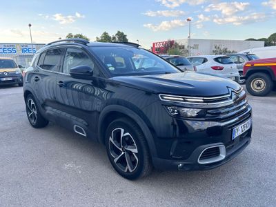 a black suv parked in a parking lot next to other cars