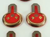 four red and gold buttons with a blue ring on them