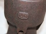 a close up of a rusted metal object on a white surface