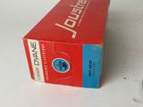 a box of toothpaste sitting on a table next to a toothbrush