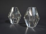 two clear glass vases sitting on a black surface