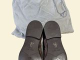 a pair of shoes that are next to a bag