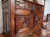a large wooden cabinet with carvings on top of it