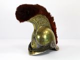 an old helmet with fur on top of it sitting on a white surface