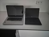 two laptops that are sitting on a white table