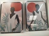 two framed pictures of a woman and a man on the wall