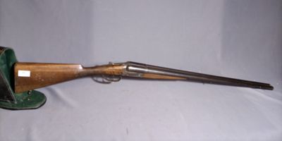 an old gun is sitting on a table with a white background