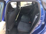 the back seat of a blue car with the door open