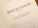 book on a wooden table with a white cover and a black and white picture