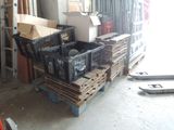 a pile of crates sitting on a pallet in a garage