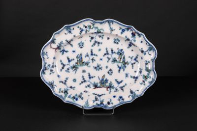 a blue and white plate with a floral design on it
