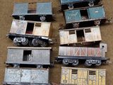four toy trains sitting next to each other on the ground