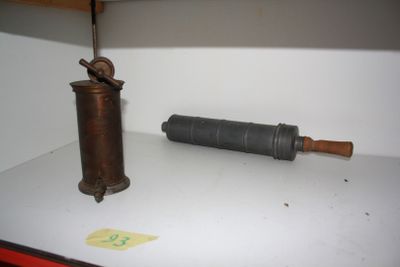 a small metal object sitting on a shelf next to a bottle