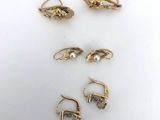 five pairs of gold earrings and a pair of pearl earrings