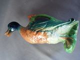 a ceramic duck that is sitting on a table