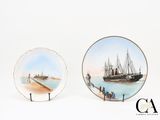 two plates with a painting of a ship and a boat on them